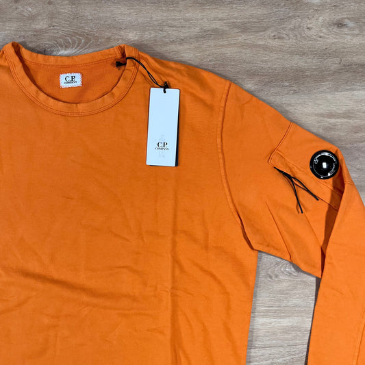 CP Company Light Fleece Crewneck Lens Sweatshirt in Russet Orange Castmark